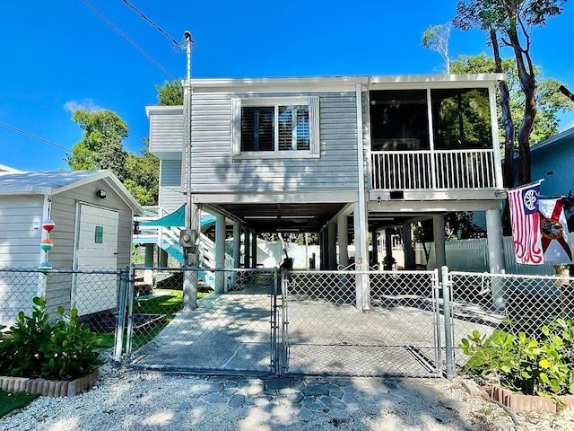 raised beach house featuring a carport