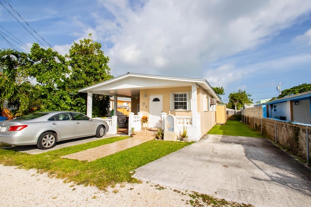 bungalow-style home with a front yard and a carport