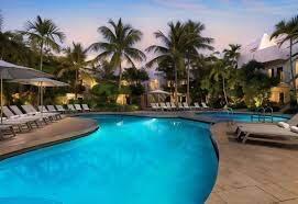 pool at dusk featuring a patio