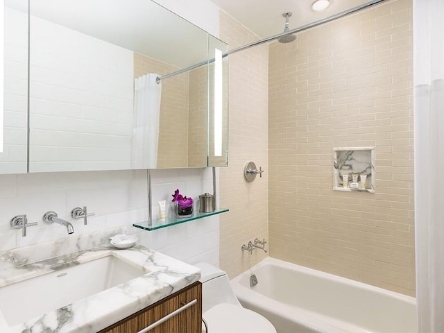 full bathroom featuring tile walls, tasteful backsplash, vanity, shower / bath combination with curtain, and toilet