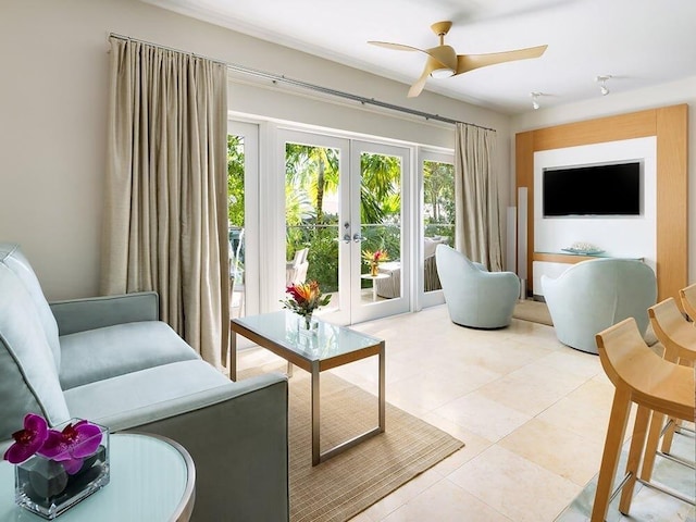 tiled living room with ceiling fan and french doors