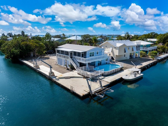 back of property featuring a water view and a sunroom