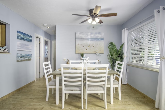 dining space featuring ceiling fan and light hardwood / wood-style flooring