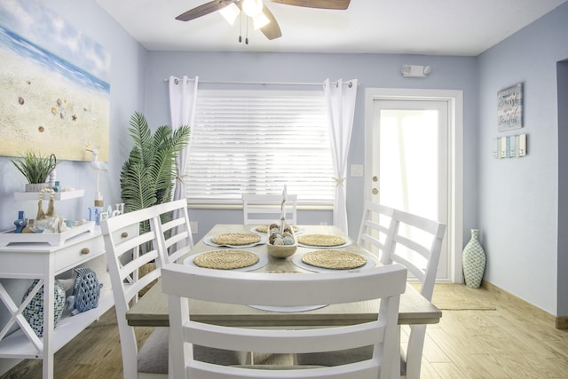 dining area featuring wood-type flooring and ceiling fan