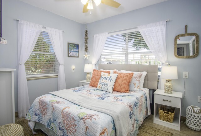 bedroom featuring ceiling fan and multiple windows