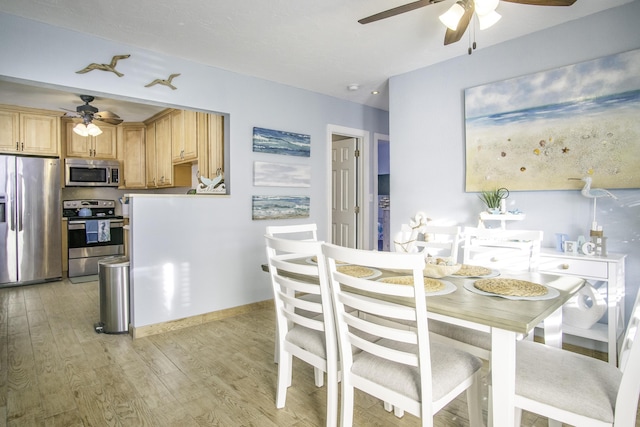 dining area with ceiling fan and light wood-type flooring