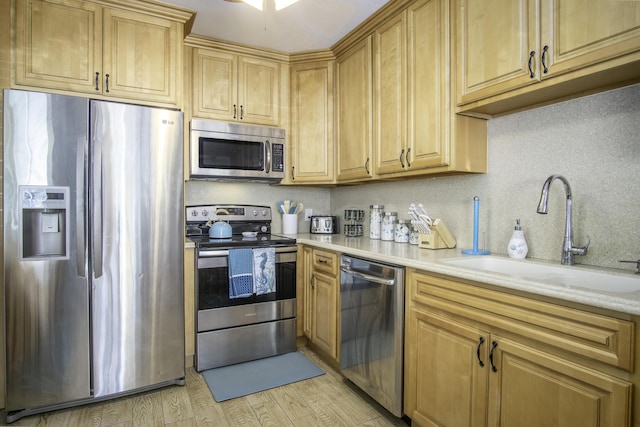 kitchen featuring sink, stainless steel appliances, and light wood-type flooring