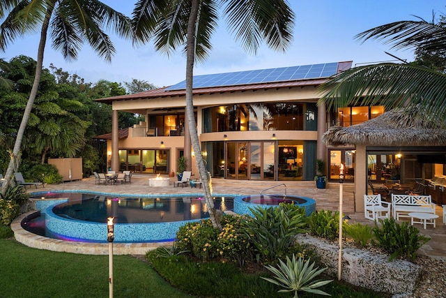 pool at dusk with a patio