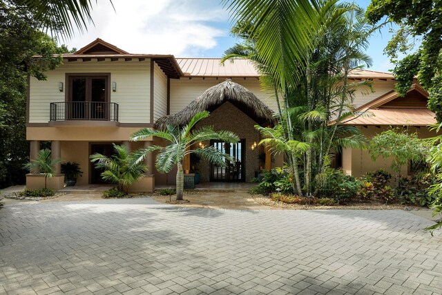 view of front facade featuring a balcony and french doors