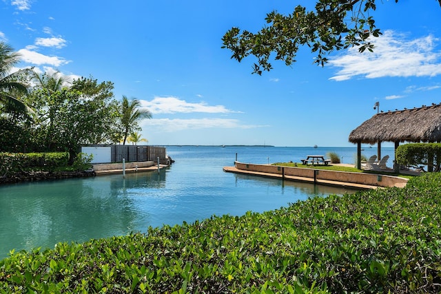 view of dock with a gazebo and a water view