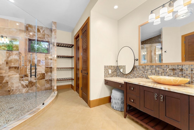 bathroom featuring a shower with door, vanity, vaulted ceiling, and backsplash