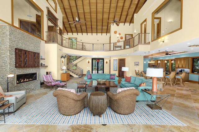 living room with wood ceiling, a fireplace, and ceiling fan