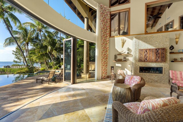 interior space with a water view and ceiling fan