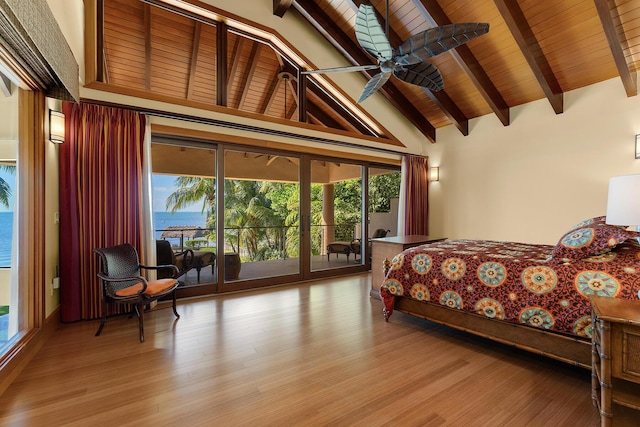 bedroom featuring multiple windows, access to exterior, and light hardwood / wood-style floors