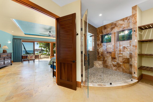 bathroom with ceiling fan and a shower with shower door