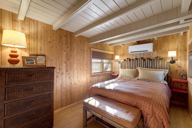 bedroom with beamed ceiling, wooden walls, hardwood / wood-style floors, and a wall unit AC