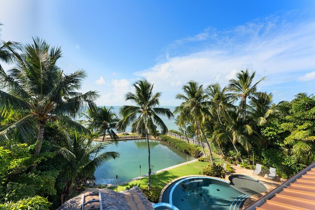 view of swimming pool with a water view