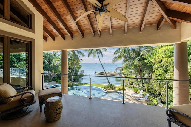 balcony featuring a water view and ceiling fan