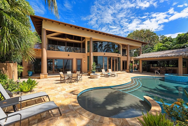 view of pool with a fire pit and a patio area