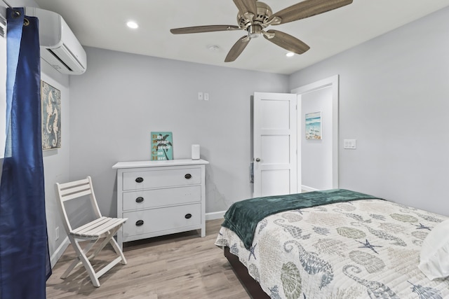 bedroom with light wood-style flooring, ceiling fan, an AC wall unit, and recessed lighting