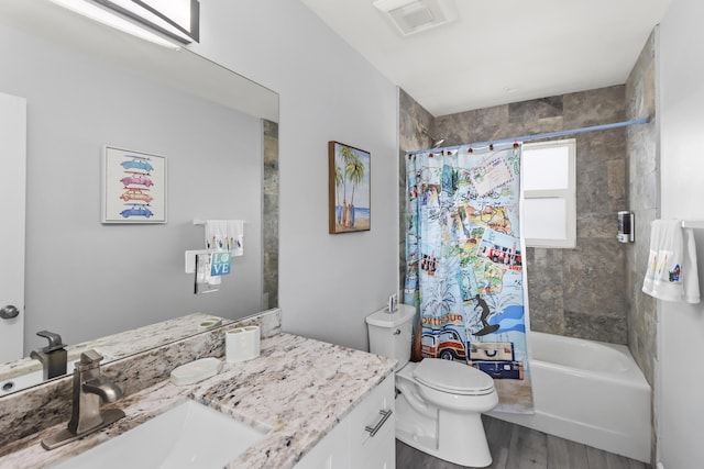 bathroom with wood finished floors, vanity, toilet, and shower / bath combo with shower curtain