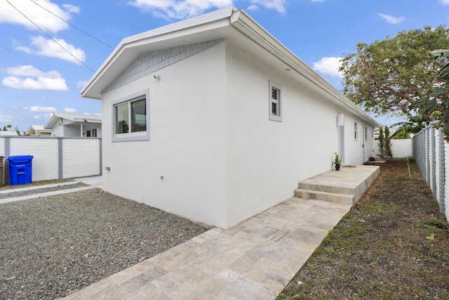 view of property exterior with a fenced backyard and stucco siding