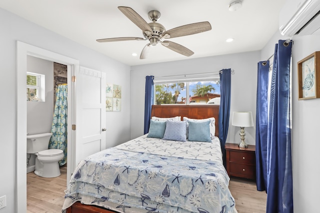 bedroom with light wood-style flooring, a ceiling fan, an AC wall unit, and recessed lighting