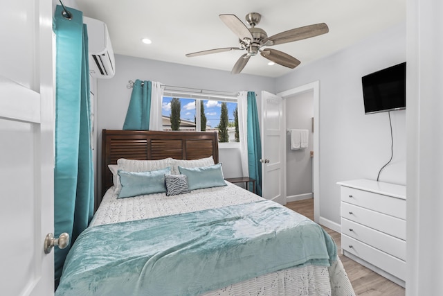 bedroom with recessed lighting, wood finished floors, a ceiling fan, baseboards, and a wall mounted air conditioner