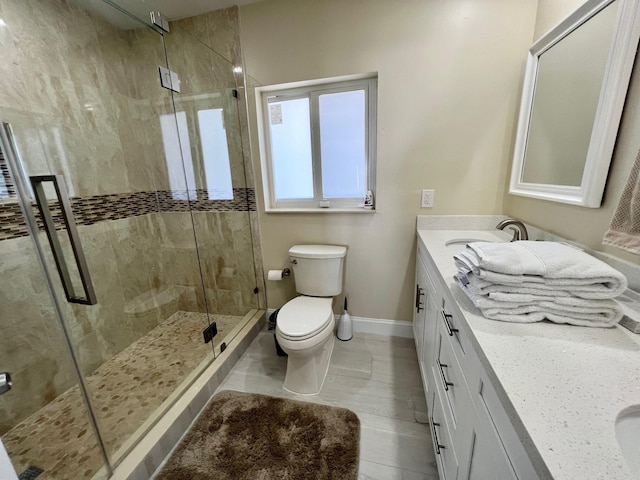 bathroom with vanity, an enclosed shower, and toilet