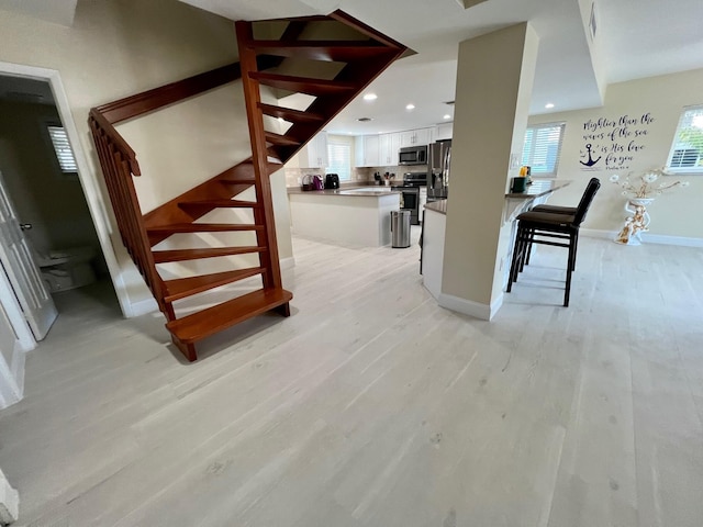 stairs featuring hardwood / wood-style flooring