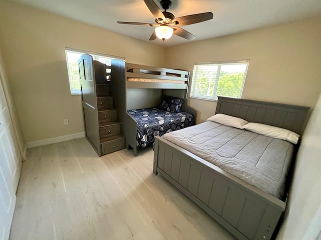 bedroom with ceiling fan and light hardwood / wood-style flooring