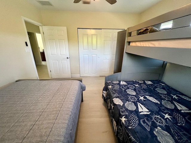 bedroom featuring ceiling fan, wood-type flooring, and a closet