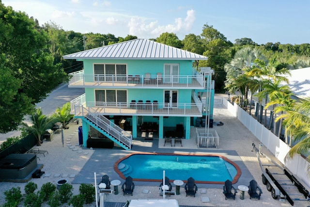 back of property featuring a patio, french doors, and a fenced in pool