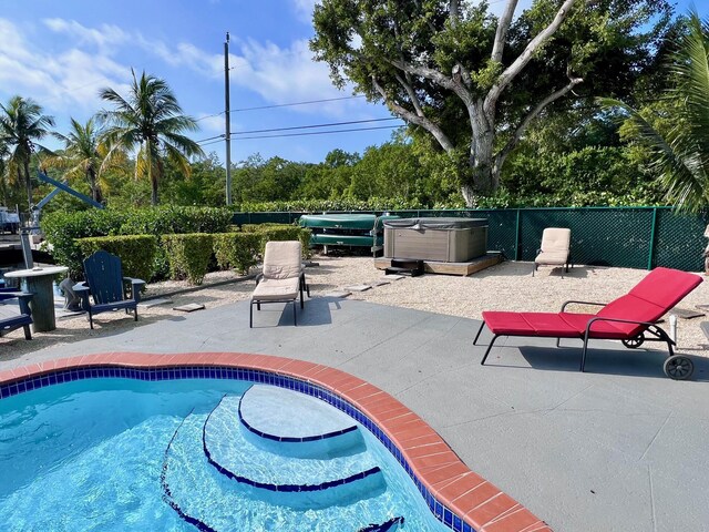 view of pool featuring a hot tub and a patio