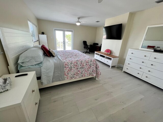 bedroom featuring access to exterior, light hardwood / wood-style floors, and ceiling fan