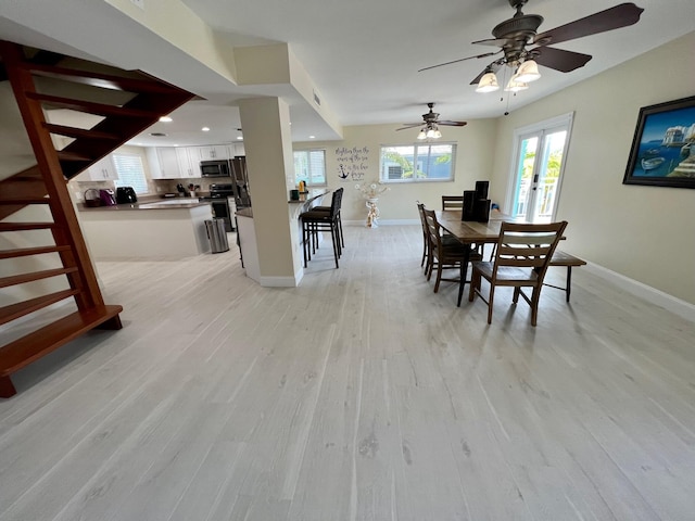 dining area with light hardwood / wood-style flooring and french doors