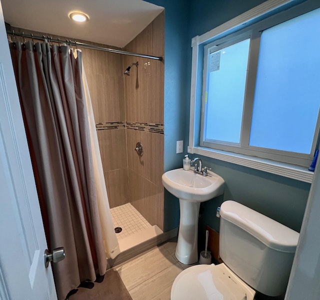 bathroom featuring toilet and a shower with shower curtain