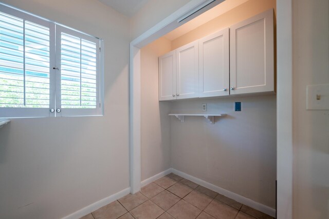 laundry area with light tile patterned flooring