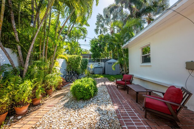 view of patio featuring a storage unit