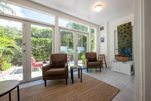 living area featuring french doors and light tile patterned floors