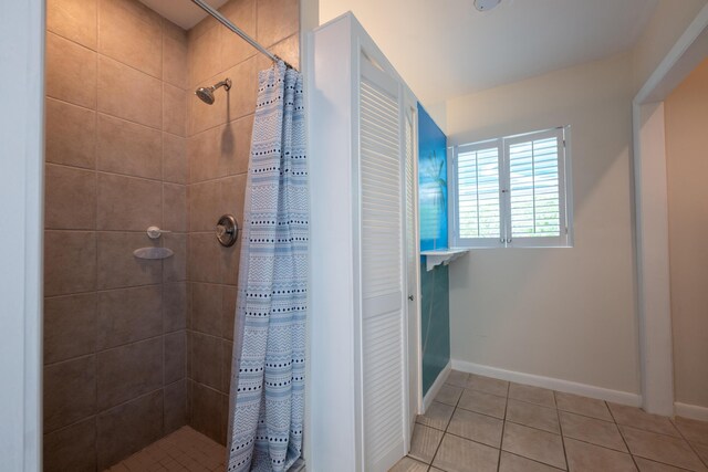 bathroom featuring tile patterned flooring and a shower with shower curtain