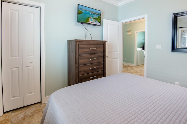 bedroom featuring ornamental molding, washer / dryer, and a closet