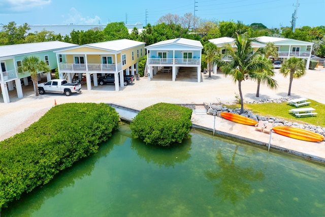 rear view of property featuring a water view and a carport