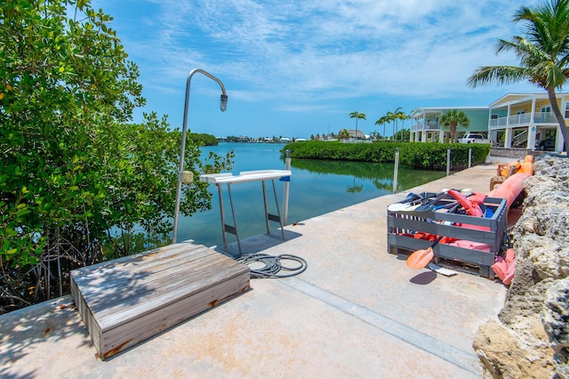 view of dock featuring a water view and a fire pit