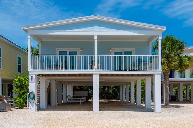 coastal home with a carport and a porch