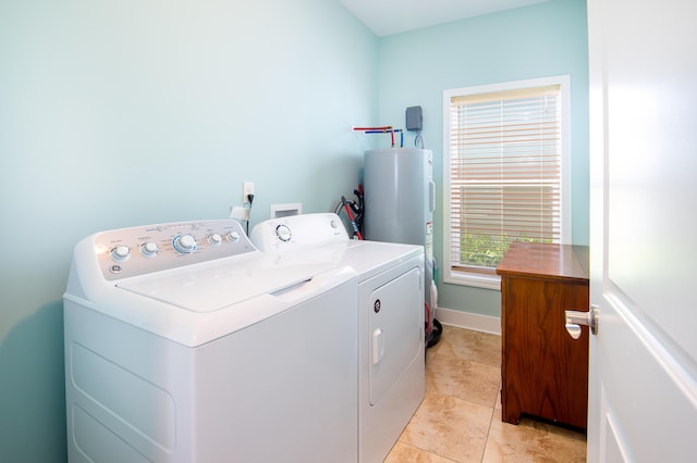 laundry area featuring separate washer and dryer, water heater, and light tile patterned flooring