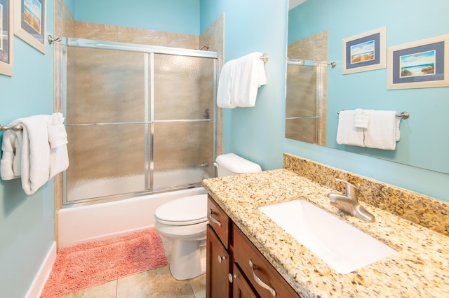 full bathroom with vanity, tile patterned floors, toilet, and combined bath / shower with glass door