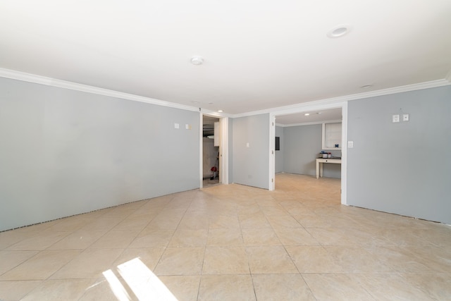 unfurnished room with light tile patterned floors and ornamental molding