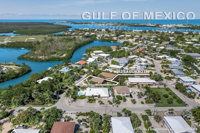 drone / aerial view with a residential view and a water view