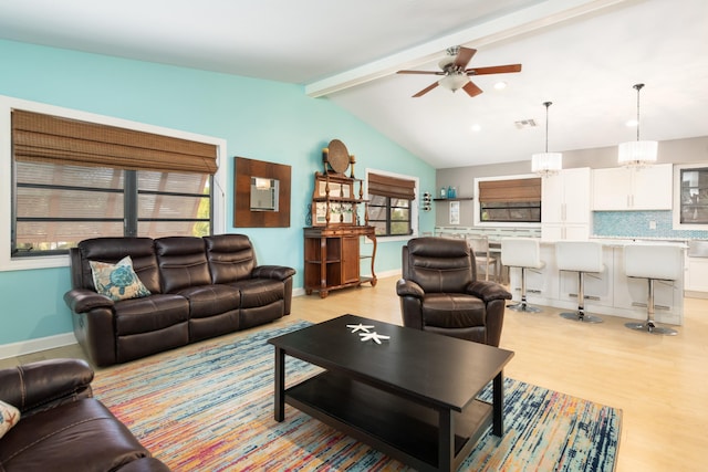 living room with baseboards, visible vents, a ceiling fan, lofted ceiling with beams, and light wood-style floors